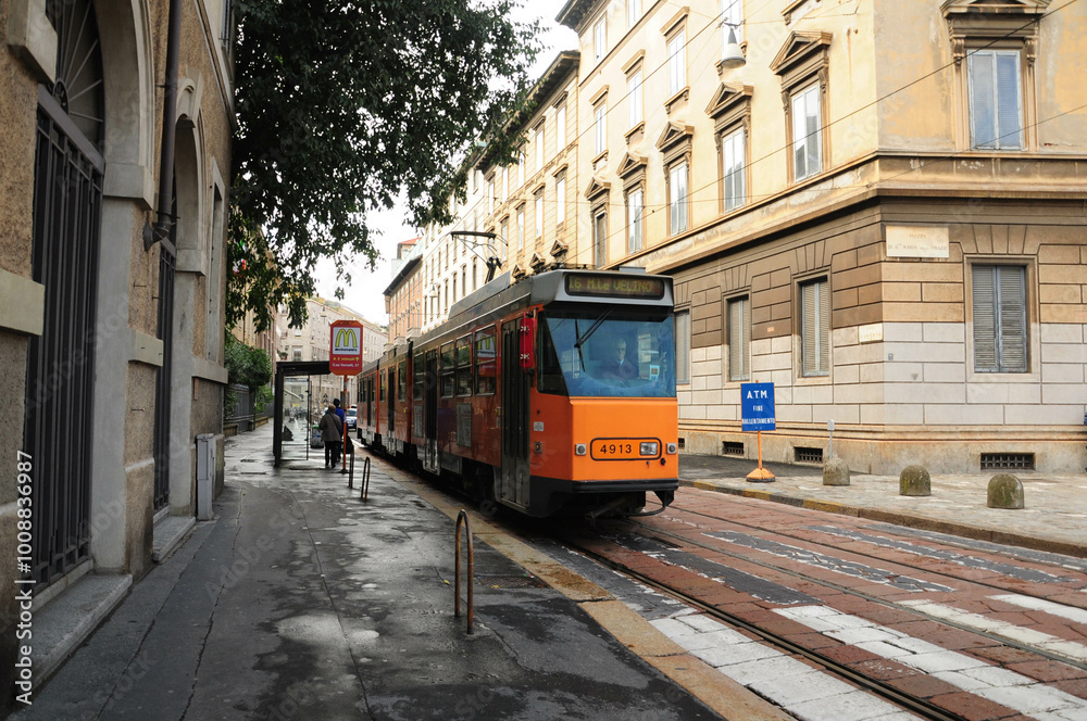 Milan, Lombardy, Italy. October 25, 2010: Historic tram on a quiet street in Milan, Italy. Milan, Lombardy, Italy. October 25, 2010: Historic tram on a quiet street in Milan, Italy.