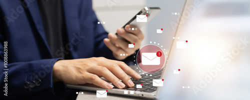 close up businessman hand type on laptop devices for received unread spam e-mail listing or phishing mail in the mailbox with virtual interface for system security and technology in business concept