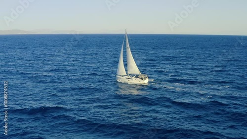 Sailing boat with white sails, cloudy sky and rippled sea background video footage 4k,