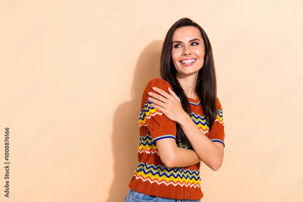 Portrait of pretty young lady hug shoulders look empty space wear t-shirt isolated on beige color background Portrait of pretty young lady hug shoulders look empty space wear t-shirt isolated on beige color background