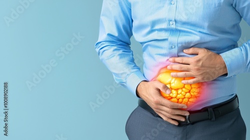 A man experiencing abdominal pain, holding his stomach, depicting discomfort and bloating in a professional setting.