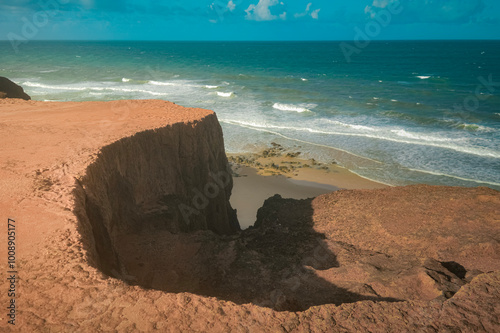 Beach seen from the top of the mountain, blue sky, nature, mountain, cliffs, Tropical climate, summer climate, beach day - Photo in Praia da Pipa - RN, Brazil photo