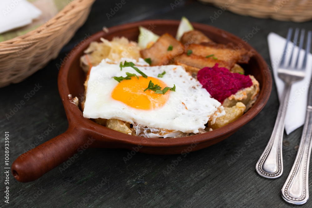 Scrambled eggs with fried bacon and potatoes served on plate Scrambled eggs with fried bacon and potatoes served on plate