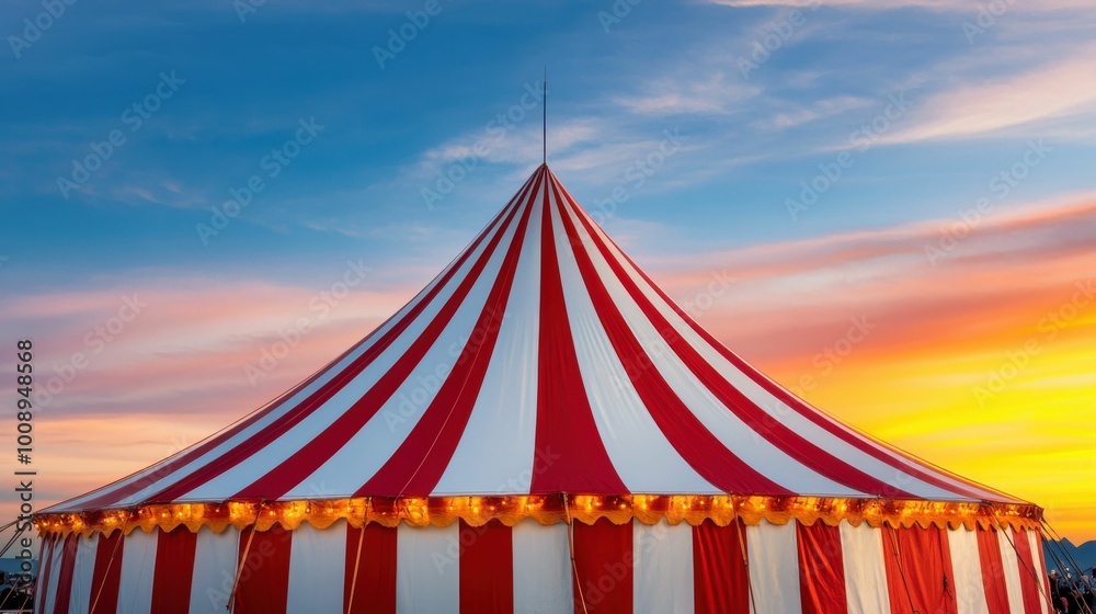 A classic red and white striped circus tent with glowing lights stands out against a vibrant sunset sky, creating a festive outdoor scene.. A classic red and white striped circus tent with glowing lights stands out against a vibrant sunset sky, creating a festive outdoor scene..