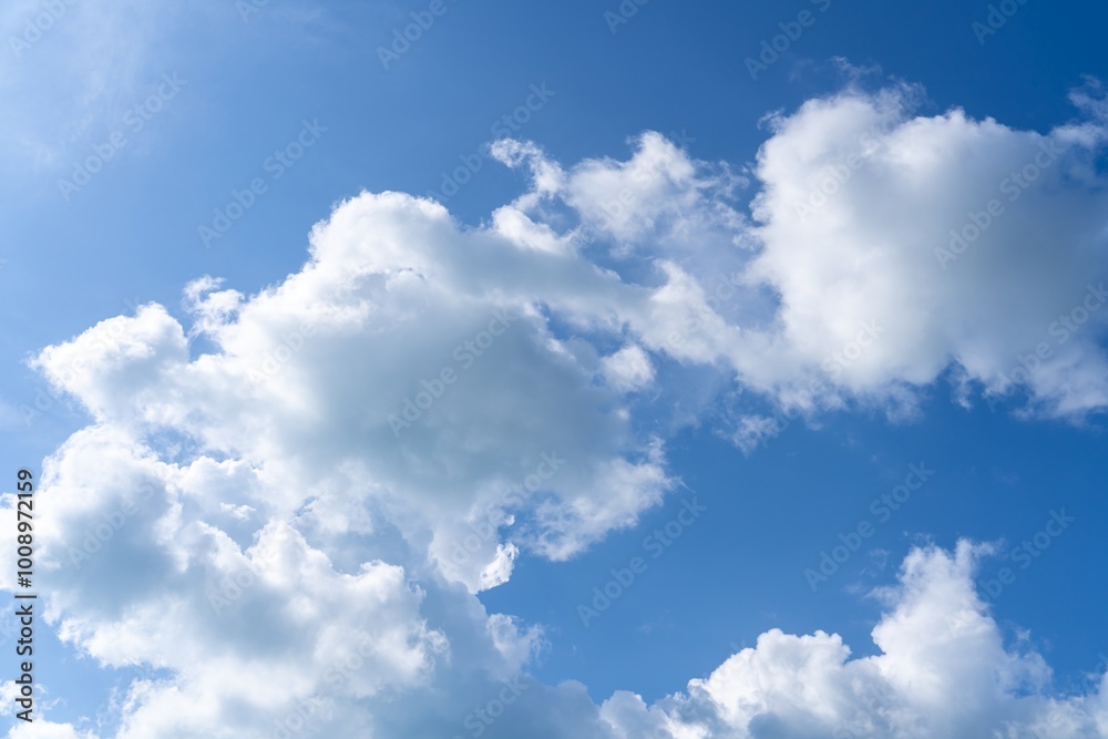 Beautiful blue sky and clouds natural background. Cumulus clouds in the blue sky. White fluffy clouds on blue sky in summer. Beautiful blue sky and clouds natural background. Cumulus clouds in the blue sky. White fluffy clouds on blue sky in summer.