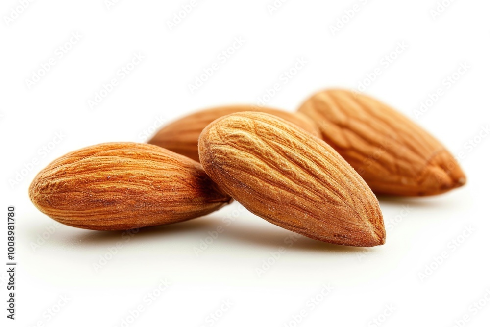 A group of almonds arranged on a clean white surface A group of almonds arranged on a clean white surface