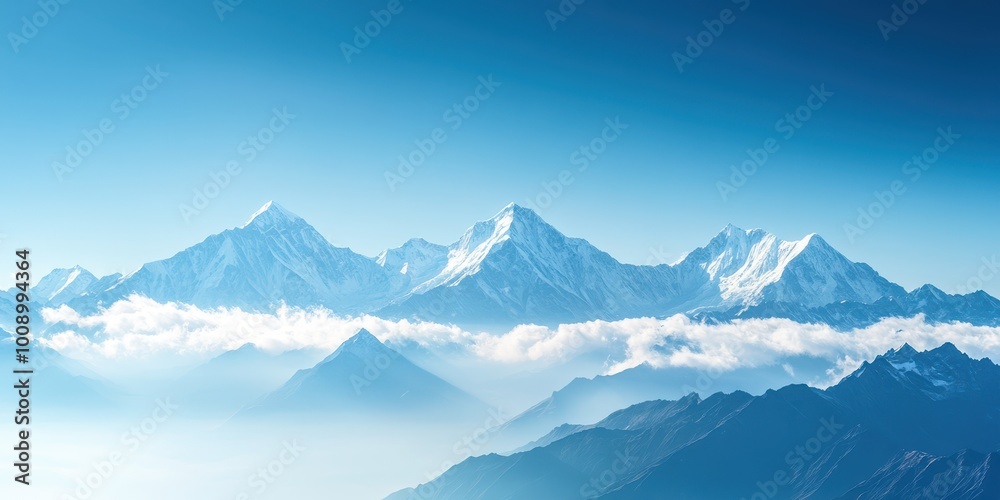 Majestic mountain peaks rise above a sea of clouds under a clear blue ...