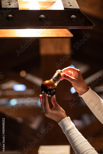 A bottle of balsamic vinegar exposed to the light for a quality check