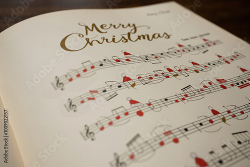 A music sheet for a Merry Christmas song, with musical notes adorned with Santa hat. Concept on the spirit of Noel, caroling, singing and spreading Yuletide joy and festive cheer, celebrating Xmas.