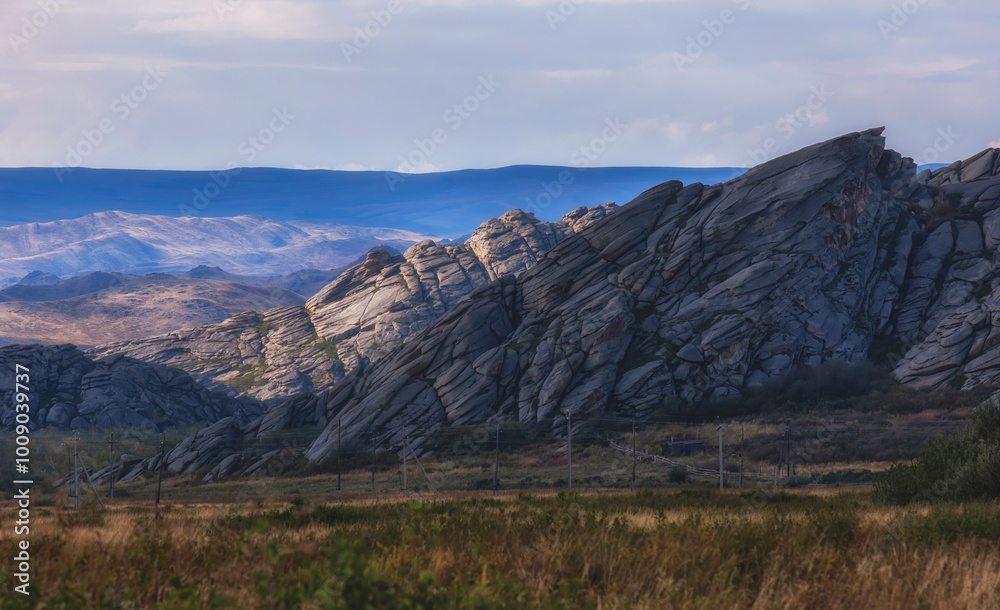 Beautiful rocky and layered mountains in Eastern Kazakhstan near the Sibinsk lakes under a stunning sunset sky Beautiful rocky and layered mountains in Eastern Kazakhstan near the Sibinsk lakes under a stunning sunset sky