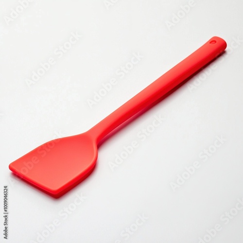 A red silicone spatula used for cooking and baking.