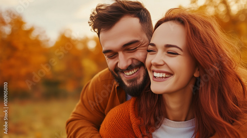 Young Happy Couple Enjoying Sunny Outdoor Autumn Day with Maple Trees, Woman and Man Smiling in Cosy Sweater, Fun Golden Season, Cosy Fall Lifestyle.