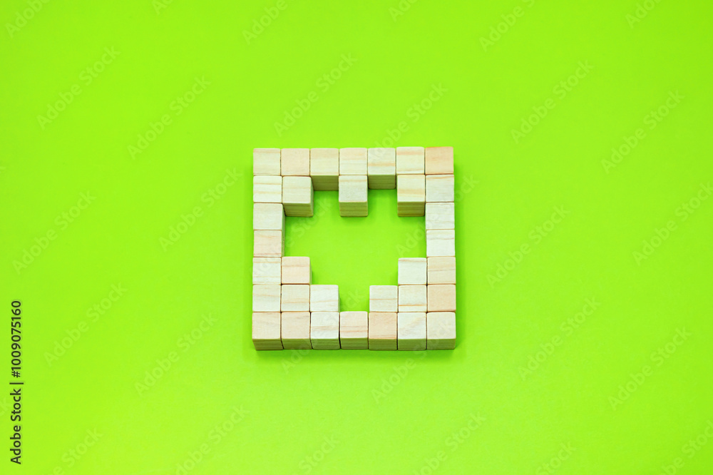 Obraz premium 黄緑色の背景でハートの形のスペースがある四角く並べた立体的なブロック