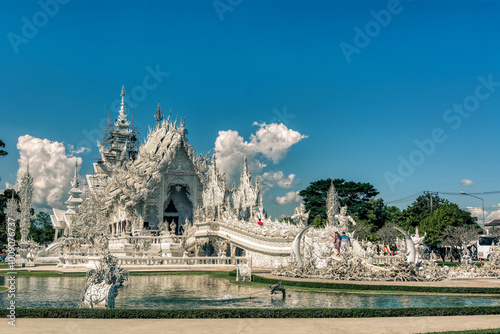 White Temple Chiang Rai Thailand, Wat Rong Khun Northern Thailand with reflection in the pond, panoramic view. photo