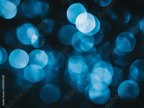 Blurred light blue circles on a dark background. Abstract bokeh lights.