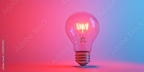 Illuminated Light Bulb on a Teal Background