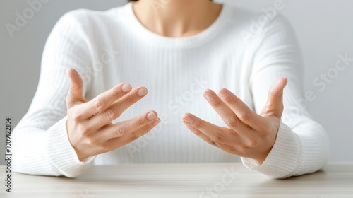 A person gesturing with their hands, conveying a sense of explanation or emotion. This represents communication and interaction.