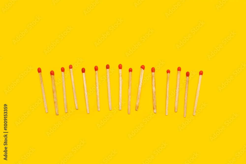 Wooden matches sticks on a yellow background with copy space Wooden matches sticks on a yellow background with copy space