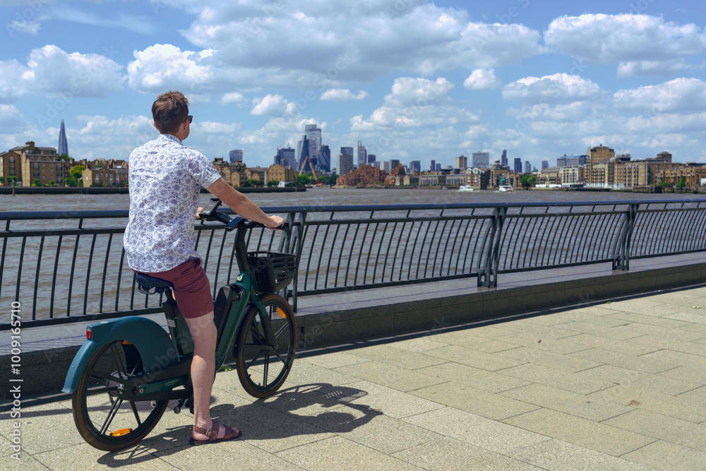 Man riding bicycle in Canary Wharf, London