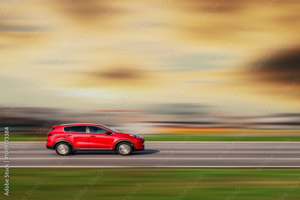 Red color car driving at high speed with blurred background Red color car driving at high speed with blurred background