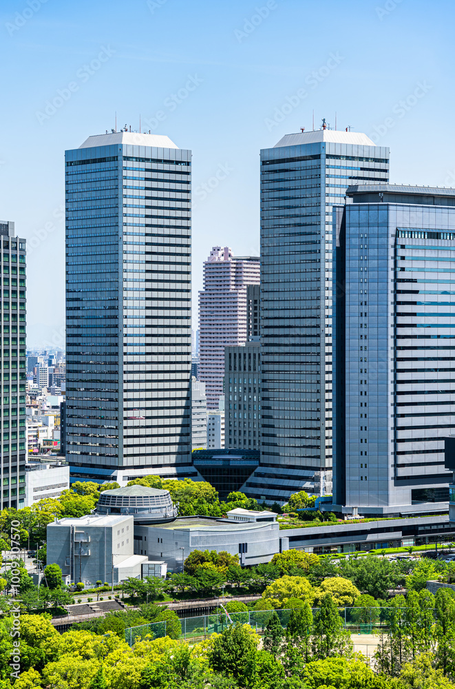 Modern glass skyscrapers seen from the upper floors of Osaka Castle, Japan. Modern glass skyscrapers seen from the upper floors of Osaka Castle, Japan.