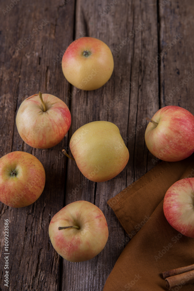 Fresh small apples and towel on wooden table
