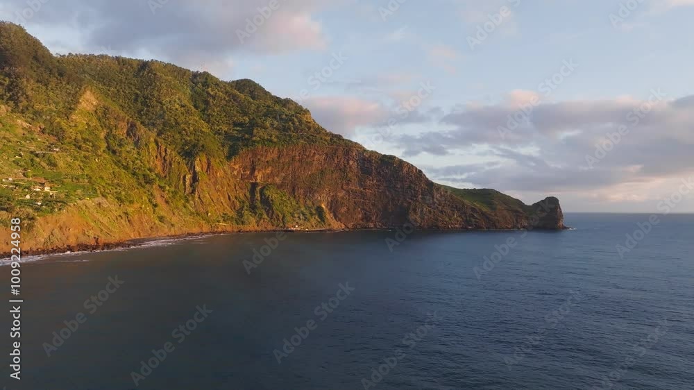 Aerial view of Madeira cliffs coastline landscape on sunrise, Guindaste viewpoint, Madeira island, Portugal. Push in approach dolly move Aerial view of Madeira cliffs coastline landscape on sunrise, Guindaste viewpoint, Madeira island, Portugal. Push in approach dolly move