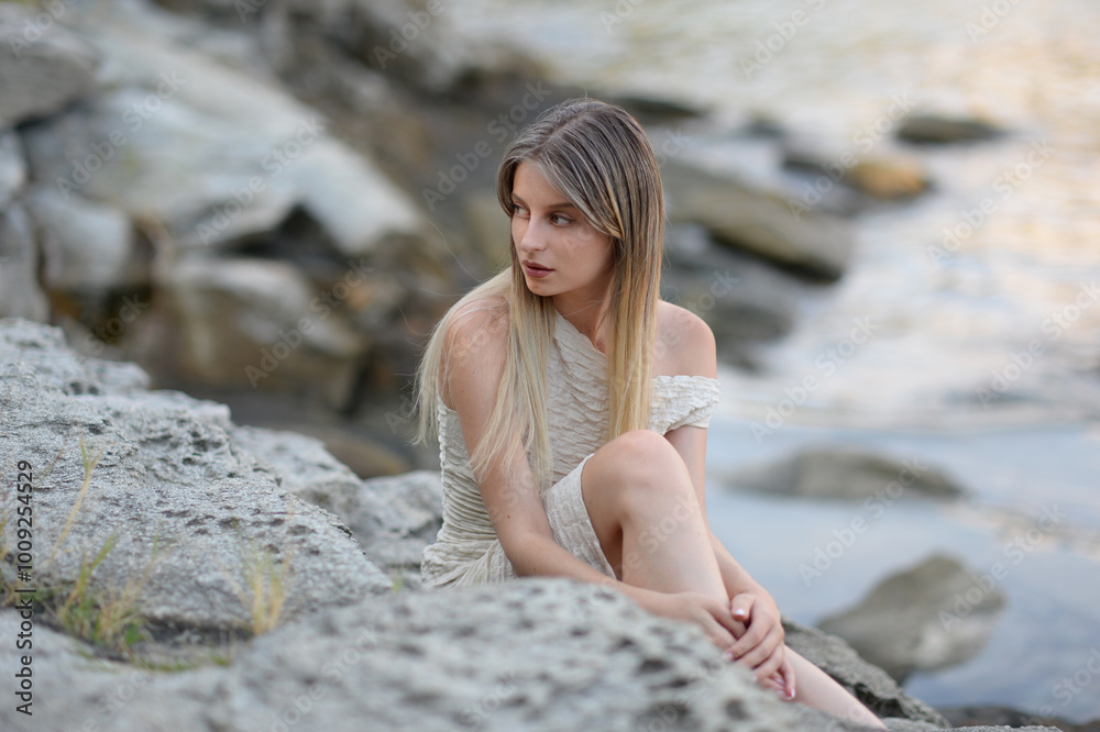 Yong woman sitting on the rocks Yong woman sitting on the rocks
