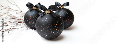 Christmas space themed balls with black bows on white background with copy-space 