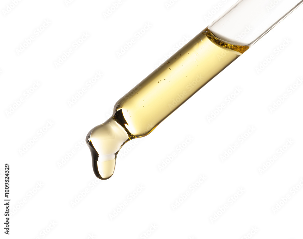 Essential oil dripping from pipette against white background Essential oil dripping from pipette against white background