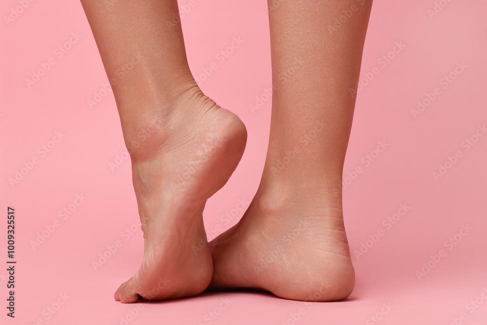 Woman with smooth feet on pink background, closeup Woman with smooth feet on pink background, closeup