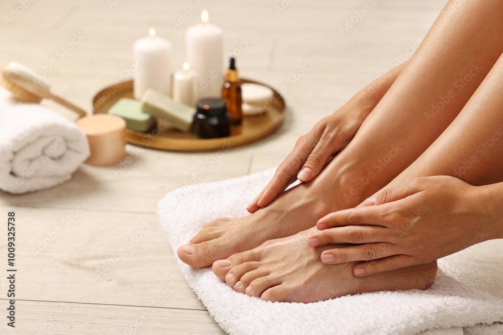 Woman touching her smooth feet on floor, closeup. Body care Woman touching her smooth feet on floor, closeup. Body care