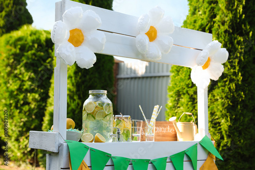 Lemonade stand with refreshing drink in park photo