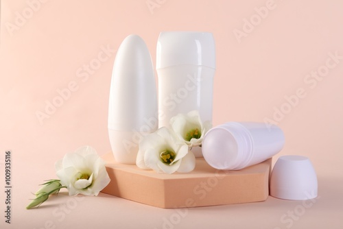 Different deodorants and beautiful eustoma flowers on beige background