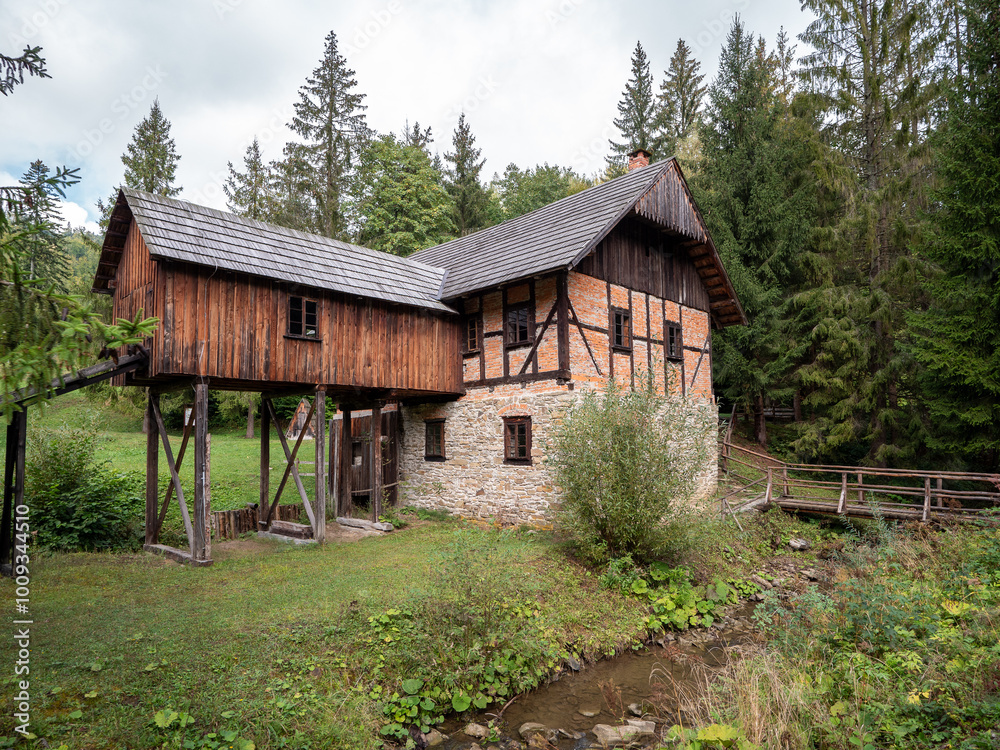 The watermill and sawmill building in the open-air museum of the Kysuck village in Nova Bystrica-Vychylovka. The mill and saw were set in motion by a wheel driven by running water. The watermill and sawmill building in the open-air museum of the Kysuck village in Nova Bystrica-Vychylovka. The mill and saw were set in motion by a wheel driven by running water.