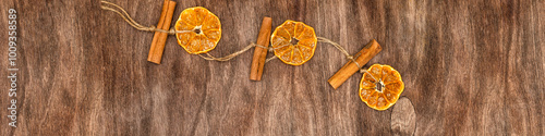 Banner 4x1 Linkedin. Pendant for Christmas with dried orange and cinnamon. Wooden background photo