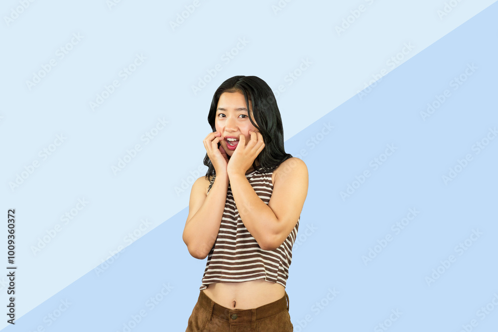 Excited Asian Student Girl gives expression hand fa gesture of sad, wow, happy, laughing in blue background Excited Asian Student Girl gives expression hand fa gesture of sad, wow, happy, laughing in blue background