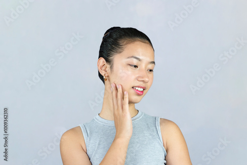 Asian Female Beauty Cosmetic Model poses with medical cream lotion beautiful expression and gesture Skincare Closeup