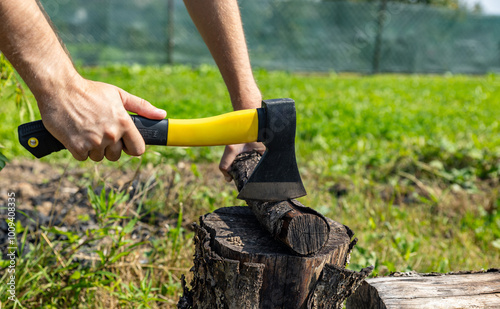 Steel axe, metal ax for wood chopping. Man holding heavy ax. Axe in lumberjack hands chopping or cutting wood trunks.