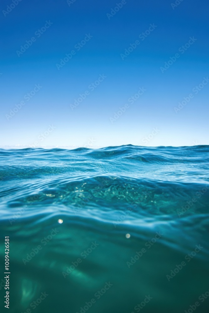 Close-up view of the crystal-clear turquoise ocean sea, with sunlight creating patterns on the water’s surface, reflecting the serenity and purity of tropical seas under a bright, cloud-filled sky. Close-up view of the crystal-clear turquoise ocean sea, with sunlight creating patterns on the water’s surface, reflecting the serenity and purity of tropical seas under a bright, cloud-filled sky.