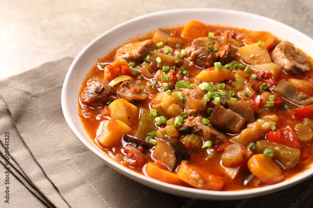 Delicious stew with vegetables in bowl on table, closeup Delicious stew with vegetables in bowl on table, closeup
