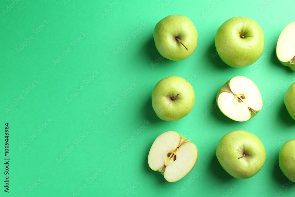 Flat lay composition with whole and cut apples on green background. Space for text Flat lay composition with whole and cut apples on green background. Space for text