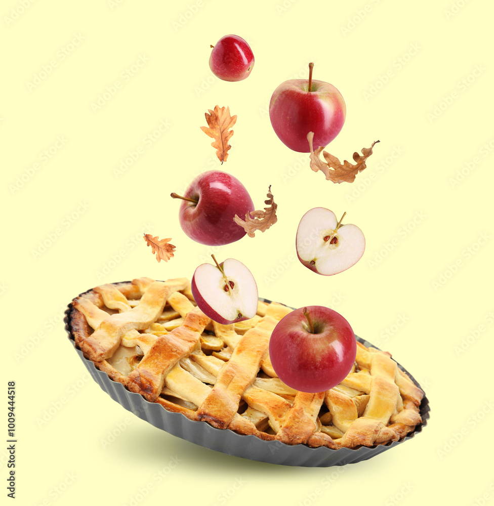 Autumn cake, apples and orange leaves in air on beige 'background Autumn cake, apples and orange leaves in air on beige 'background