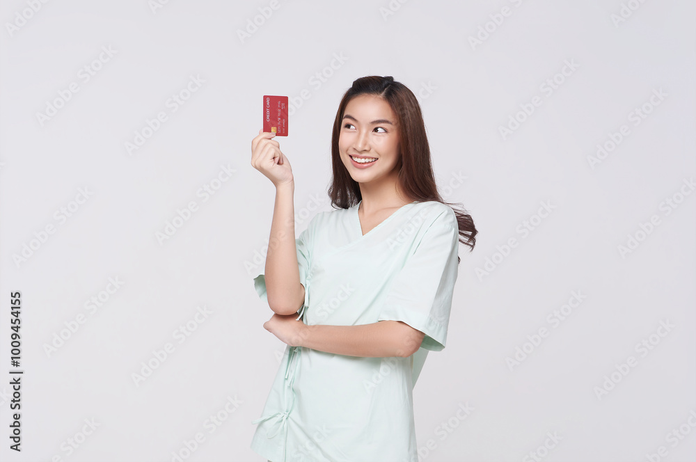 Happy asian woman patient showing credit card isolated on white background. Insurance card and payment concept Happy asian woman patient showing credit card isolated on white background. Insurance card and payment concept