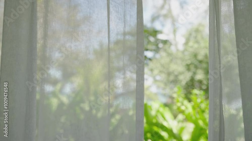 window in the garden morning. Close up wind blowing white curtain from open window tree sunshine morning. 