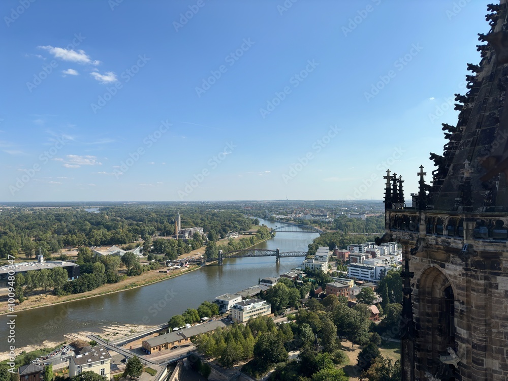 Fototapeta premium Elbe's Embrace: Magdeburg's Riverscape from the Cathedral Spire