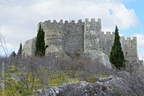 Exterior view of the fortress Stjepangrad - landmark of the city of Blagaj in Bosnia and Herzegovina. Medieval fortification in the outskirts of Mostar: monumental stone walls with a crenellated top. photo