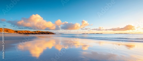  A sunset view of a cloud-dotted sky over a foreground water body at the beach
