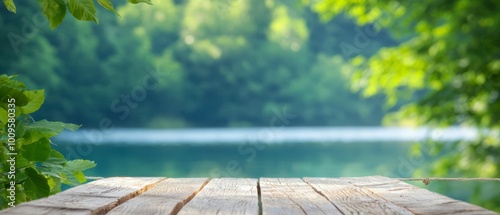 Fototapeta Naklejka Na Ścianę i Meble -   A crisp image of a wooden table against a softly blurred backdrop of trees and a tranquil waterbody in the foreground