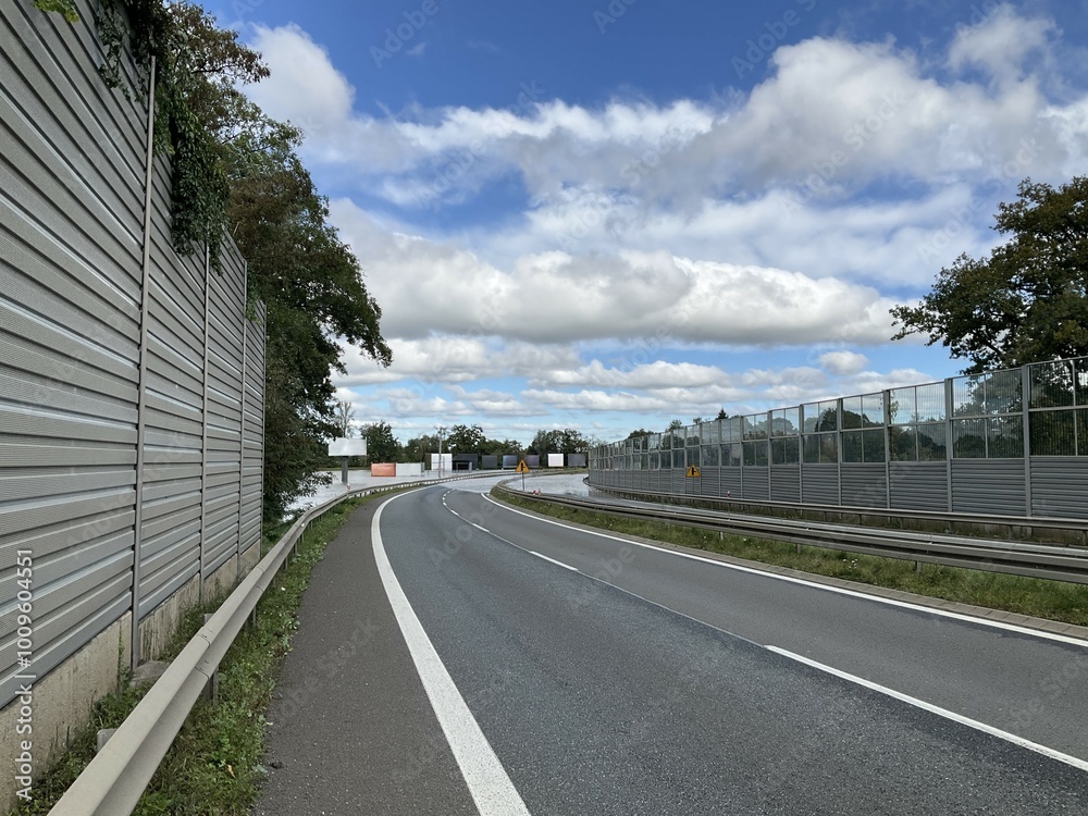 Fototapeta premium Flooded and impassable national road DK1 due to pool of water at confluence of Rivers Wapienica and Iłownica during flood in September 2024 in Poland in Czechowice Dziedzice. Topic: river alert status